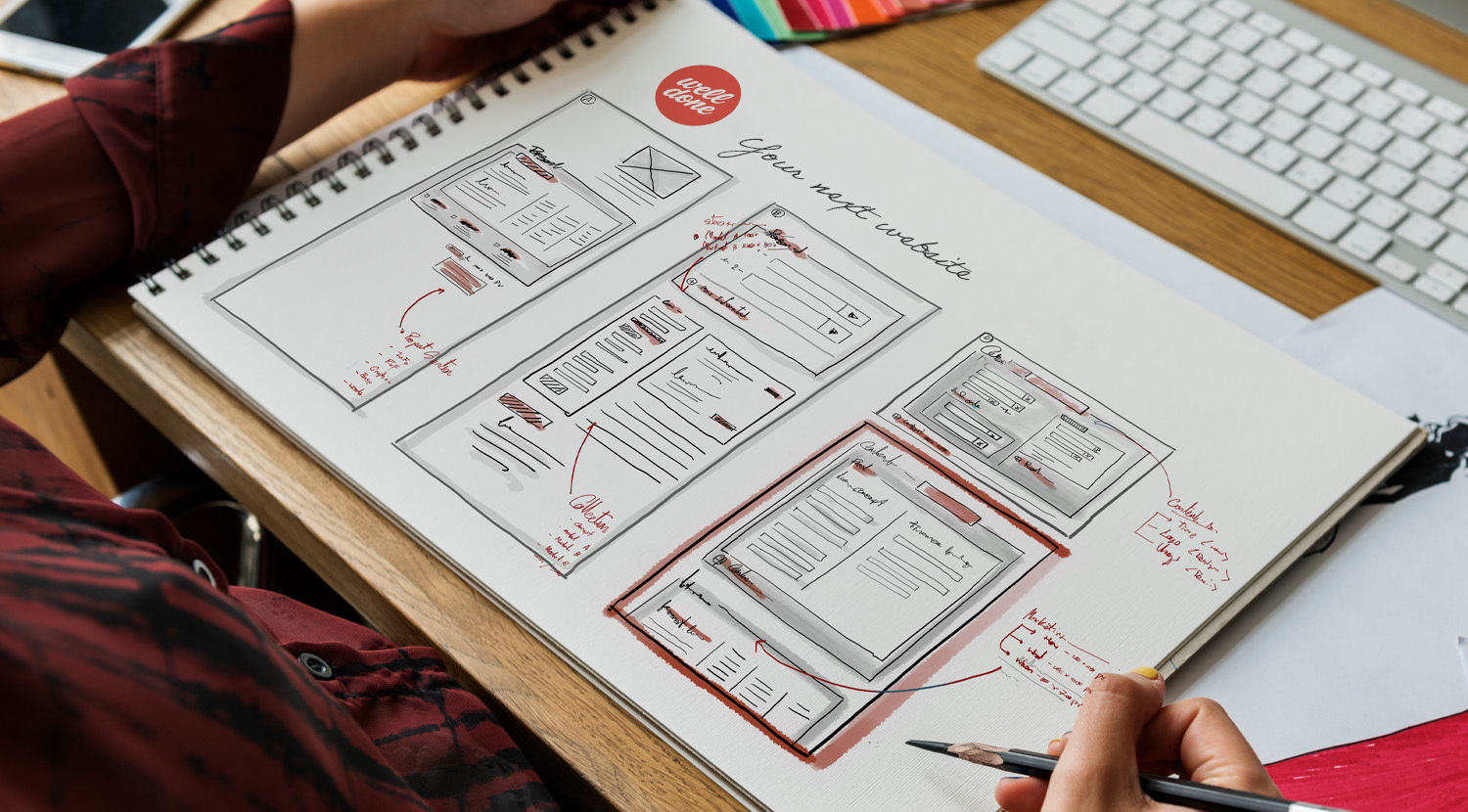 Website wireframe sketches in a notebook